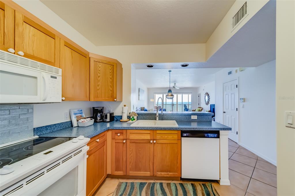 16550 Gulf Boulevard, Unit 643 North Redington Beach, FL 33708 - Photo 17 of 67 a kitchen with a sink and a stove top oven