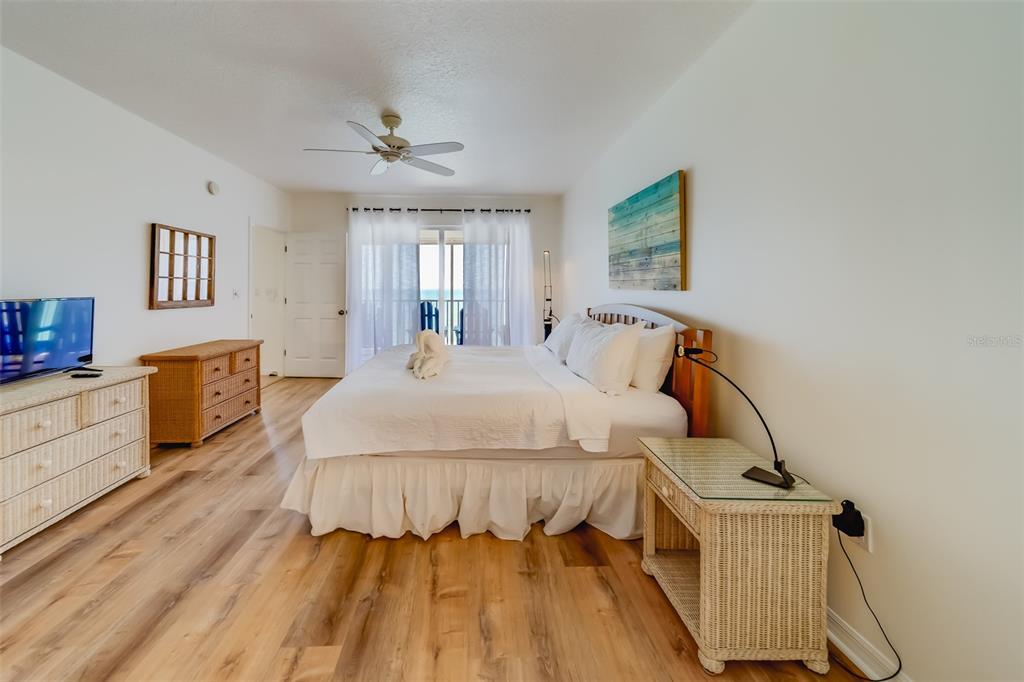 16550 Gulf Boulevard, Unit 643 North Redington Beach, FL 33708 - Photo 23 of 67 a bedroom with a bed and wooden floor