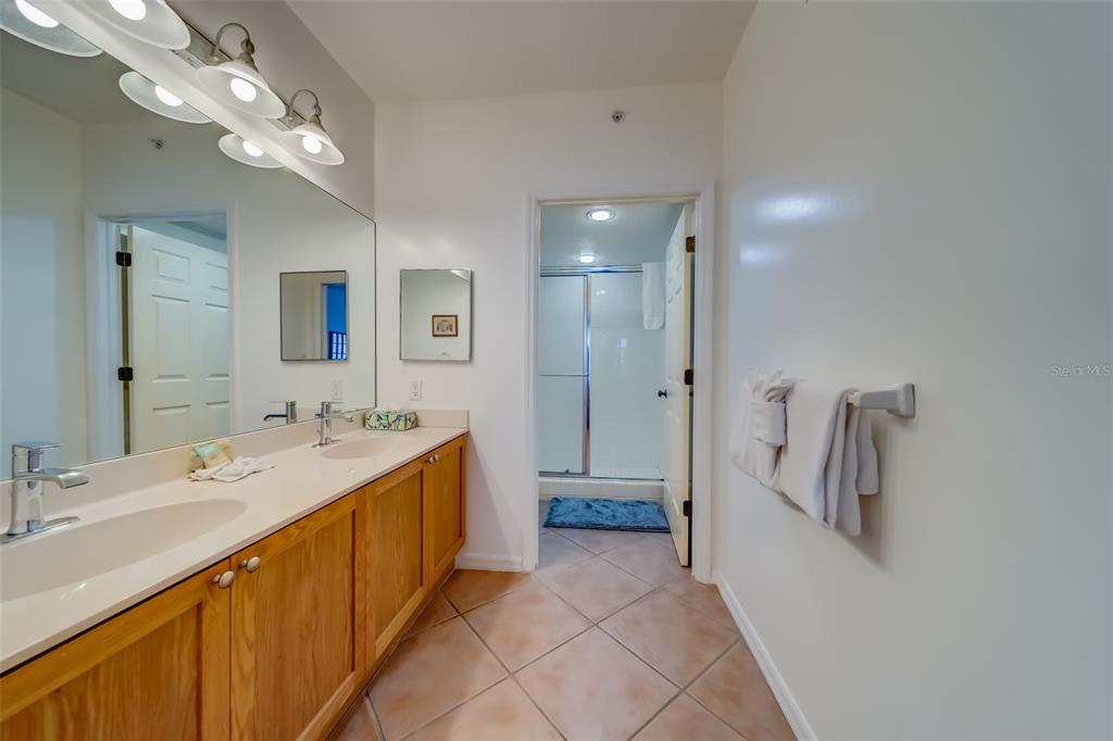 16550 Gulf Boulevard, Unit 643 North Redington Beach, FL 33708 - Photo 25 of 67 a spacious bathroom with a double vanity sink mirror and shower