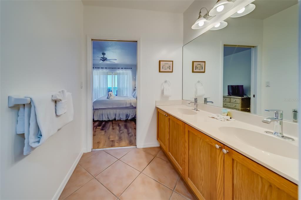 16550 Gulf Boulevard, Unit 643 North Redington Beach, FL 33708 - Photo 28 of 67 a spacious bathroom with a double vanity sink and a mirror