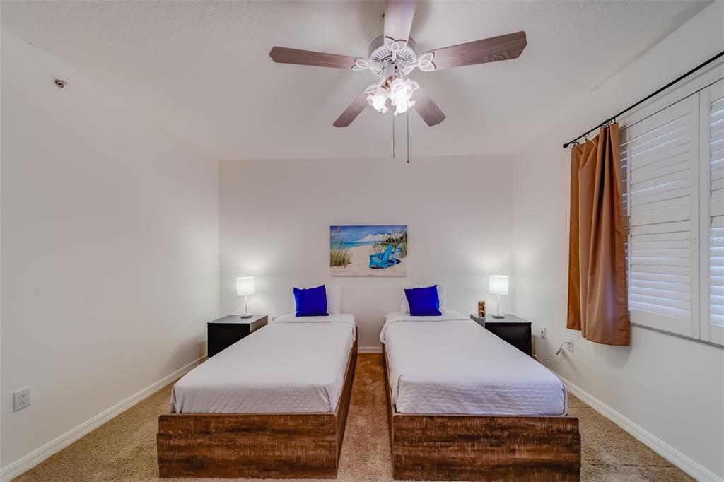 16550 Gulf Boulevard, Unit 643 North Redington Beach, FL 33708 - Photo 33 of 67 a bedroom with a bed and a chandelier