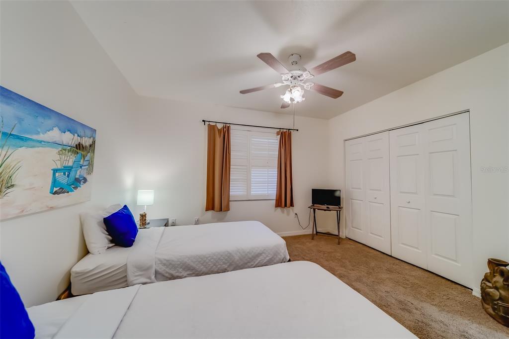 16550 Gulf Boulevard, Unit 643 North Redington Beach, FL 33708 - Photo 34 of 67 a bedroom with a large bed and a chandelier