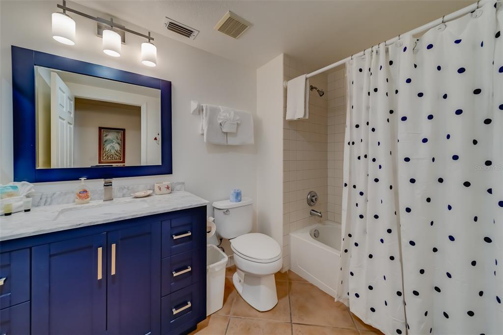 16550 Gulf Boulevard, Unit 643 North Redington Beach, FL 33708 - Photo 36 of 67 a bathroom with a toilet sink and mirror
