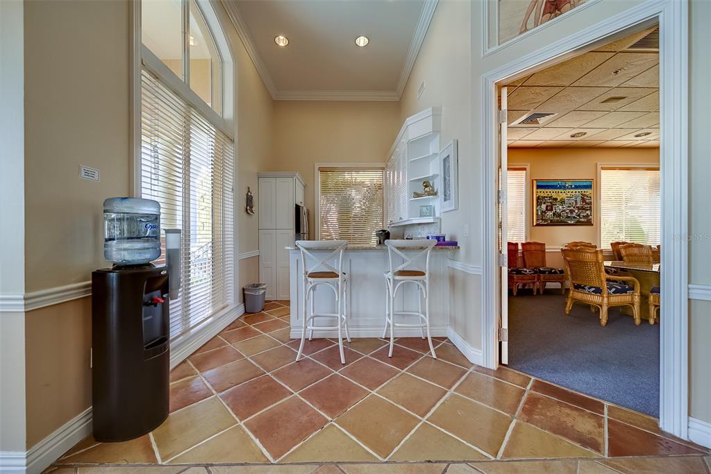 16550 Gulf Boulevard, Unit 643 North Redington Beach, FL 33708 - Photo 51 of 67 a living room with furniture a flat screen tv and a refrigerator