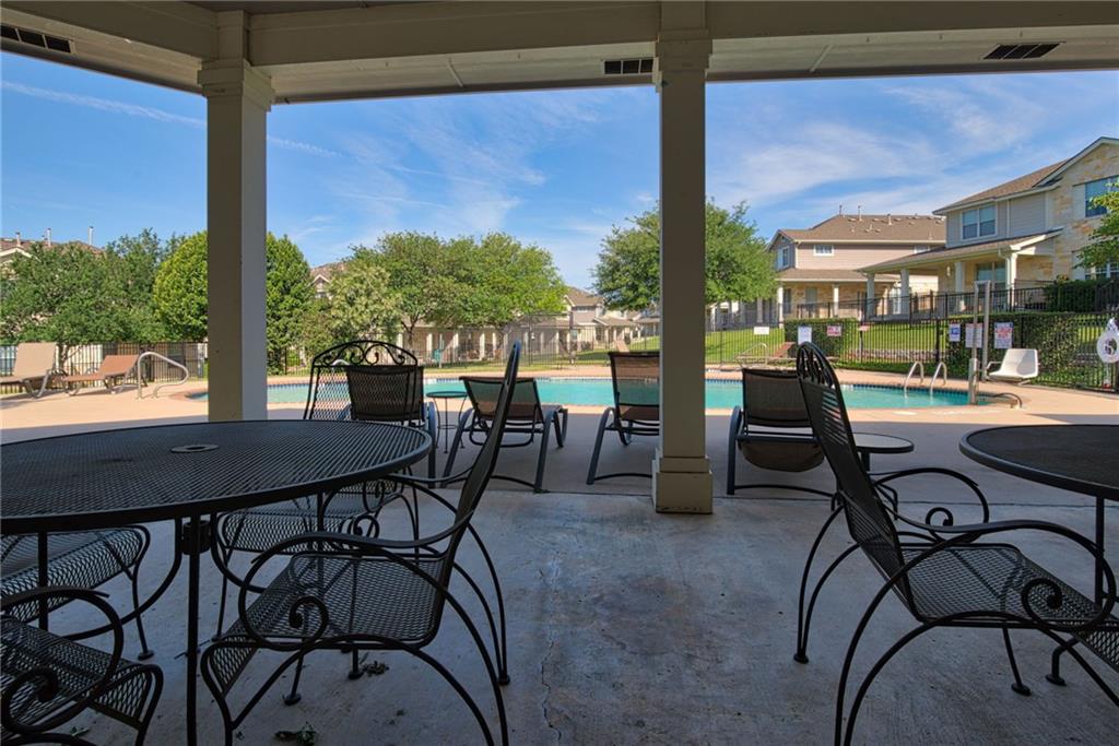1900 Scofield Ridge Parkway, Unit 5501 Austin, TX 78727 - Photo 19 of 21 Relax poolside under the covered patio, enjoying the community swimming area and surrounding green spaces.