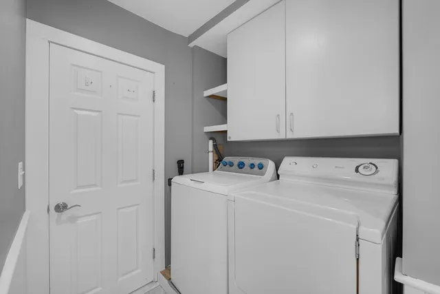 a view of storage and utility room with washer and dryer