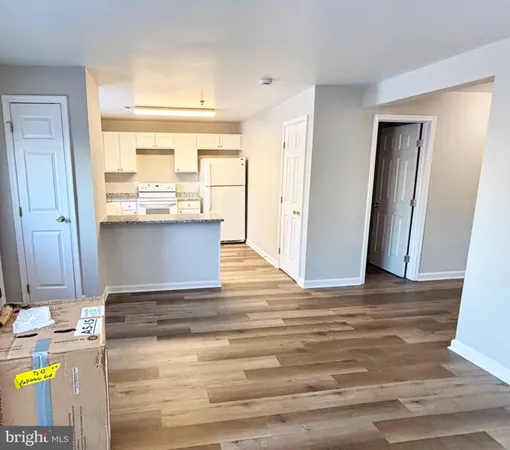 a view of a kitchen with wooden floor and a sink