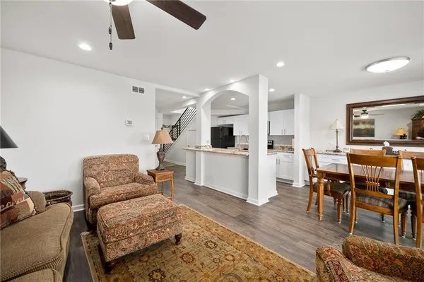 a living room with furniture and kitchen view