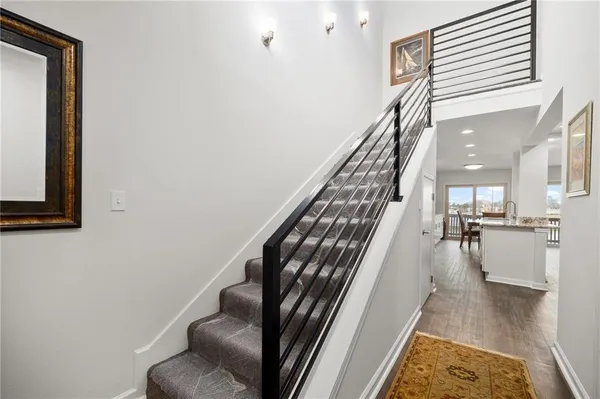 a view of entryway and hall with wooden floor