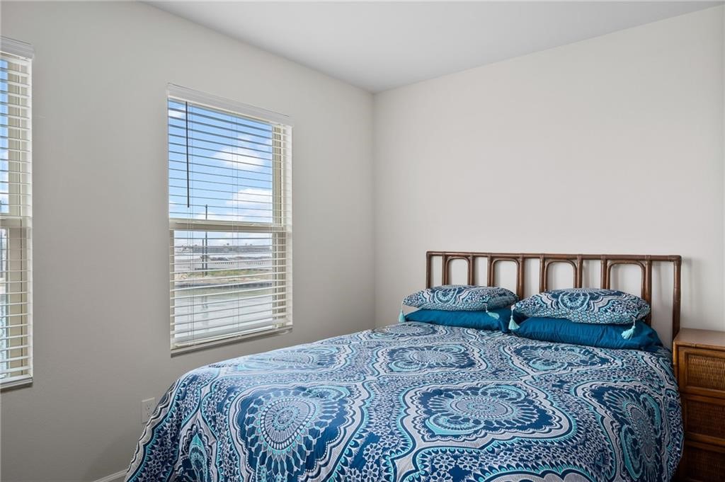 620 Fulton Beach Road, Unit 203 Rockport, TX 78382 - Photo 21 of 37 a bedroom with a bed and a window