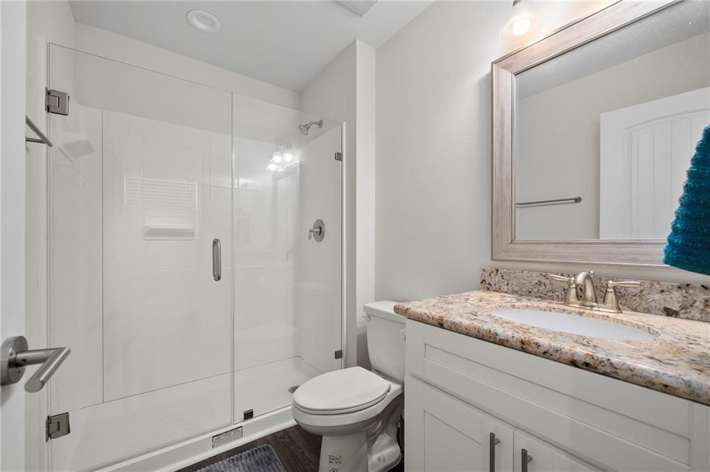 620 Fulton Beach Road, Unit 203 Rockport, TX 78382 - Photo 23 of 37 a bathroom with a granite countertop sink toilet and shower