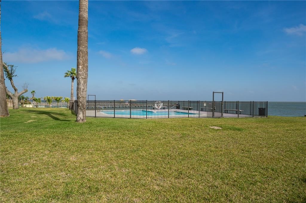 620 Fulton Beach Road, Unit 203 Rockport, TX 78382 - Photo 29 of 37 a view of a swimming pool with a yard