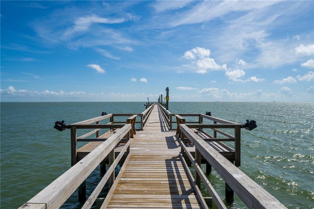 620 Fulton Beach Road, Unit 203 Rockport, TX 78382 - Photo 35 of 37 a view of a balcony with wooden floor and iron fence
