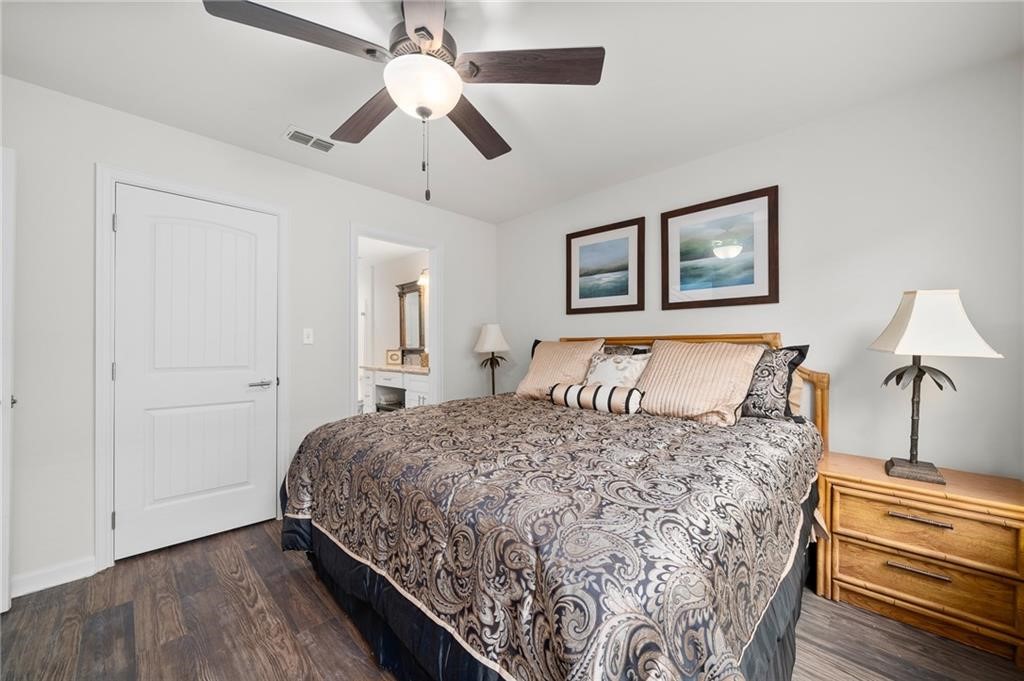 620 Fulton Beach Road, Unit 203 Rockport, TX 78382 - Photo 4 of 37 a bedroom with a bed and wooden floor