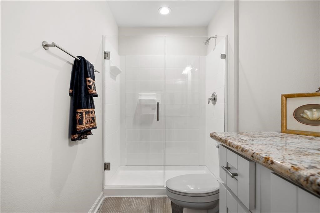 620 Fulton Beach Road, Unit 203 Rockport, TX 78382 - Photo 7 of 37 a bathroom with a granite countertop sink a toilet and shower