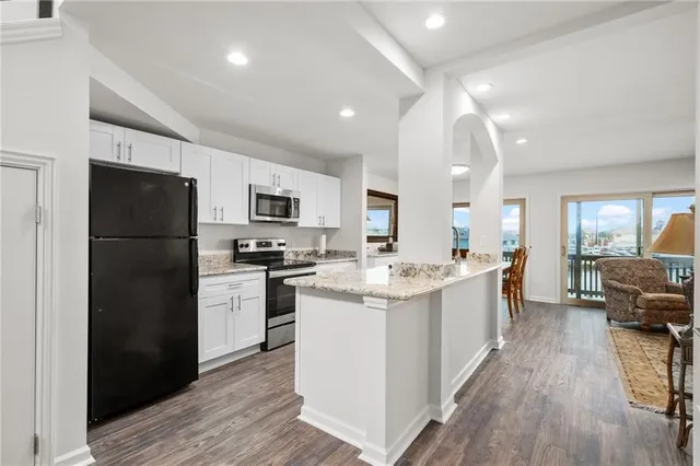 a kitchen with stainless steel appliances granite countertop a refrigerator stove and sink