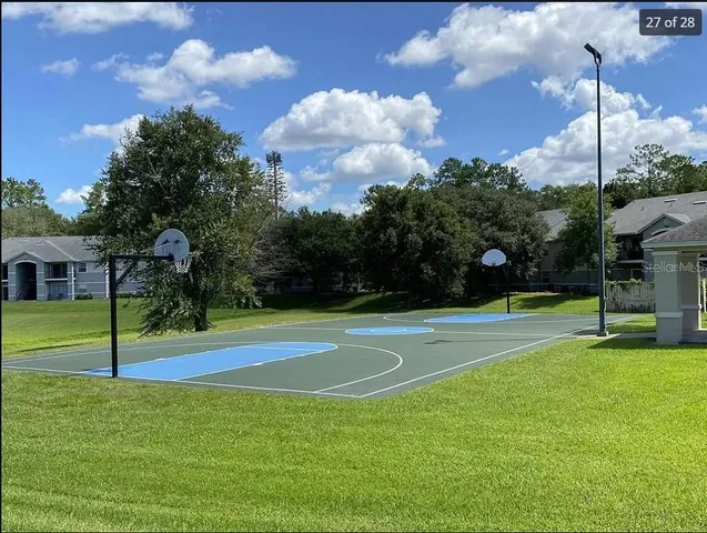 a view of a playground and basketball court