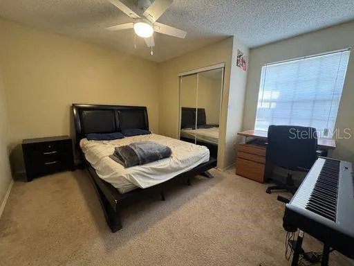 a bedroom with a bed and a piano