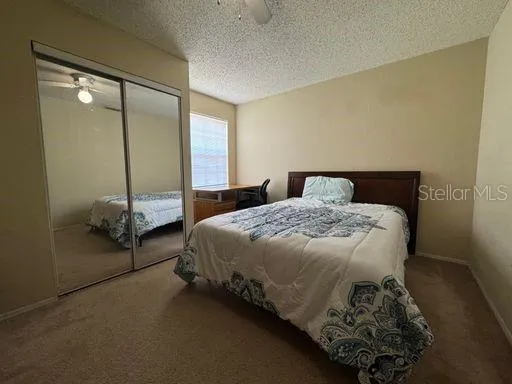 a bedroom with a bed and a mirror