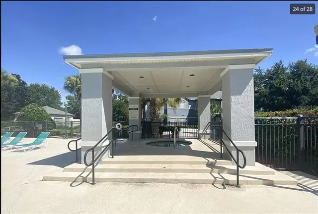 a view of a patio with a table and chairs