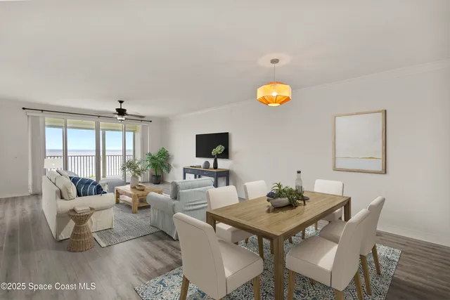 a living room with a table and a potted plant