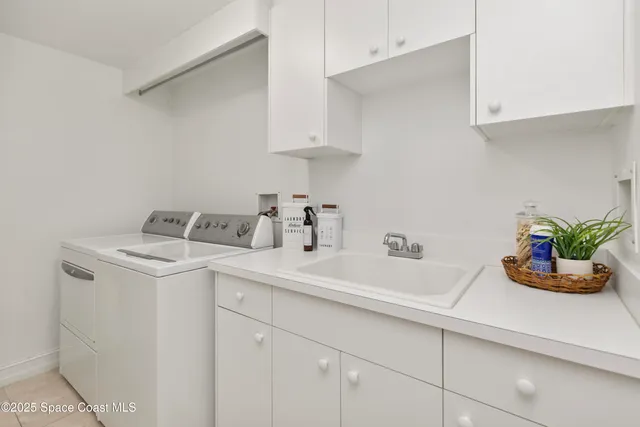 a large white room with a white bed and a dresser