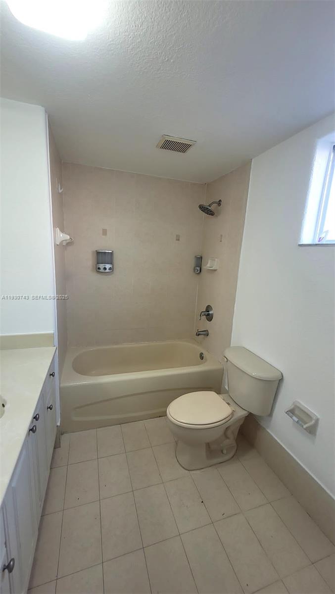 7241 Northwest 174th Terrace, Unit 103 Hialeah, FL 33015 - Photo 11 of 19 a bathroom with a granite countertop sink toilet and bathtub