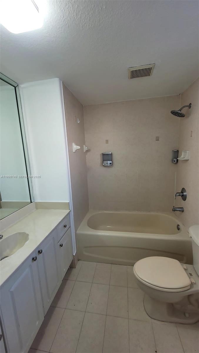 7241 Northwest 174th Terrace, Unit 103 Hialeah, FL 33015 - Photo 12 of 19 a bathroom with a bathtub sink and toilet
