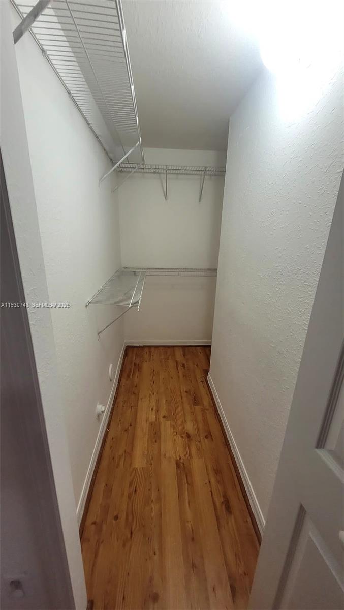 7241 Northwest 174th Terrace, Unit 103 Hialeah, FL 33015 - Photo 19 of 19 a view of wooden floor in a room
