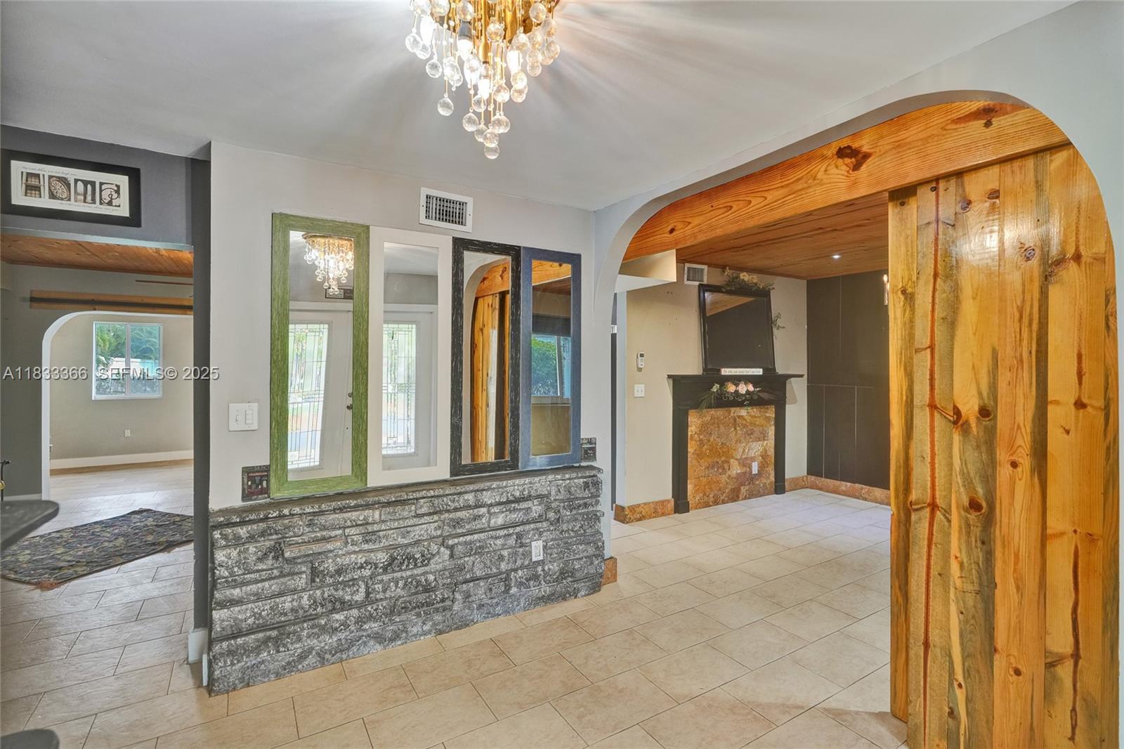 5840 Southwest 19th Street Plantation, FL 33317 - Photo 21 of 66 a view of a hallway with wooden floor and a living room