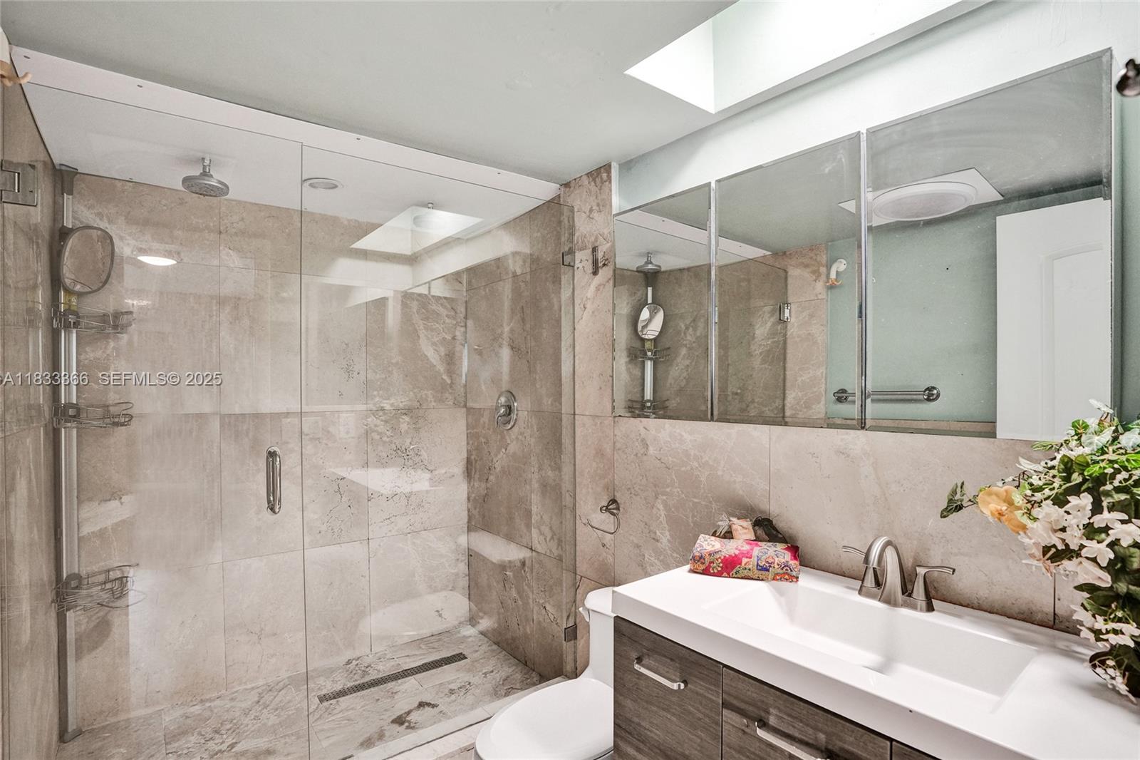 5840 Southwest 19th Street Plantation, FL 33317 - Photo 24 of 66 a bathroom with a sink vanity granite toilet and shower