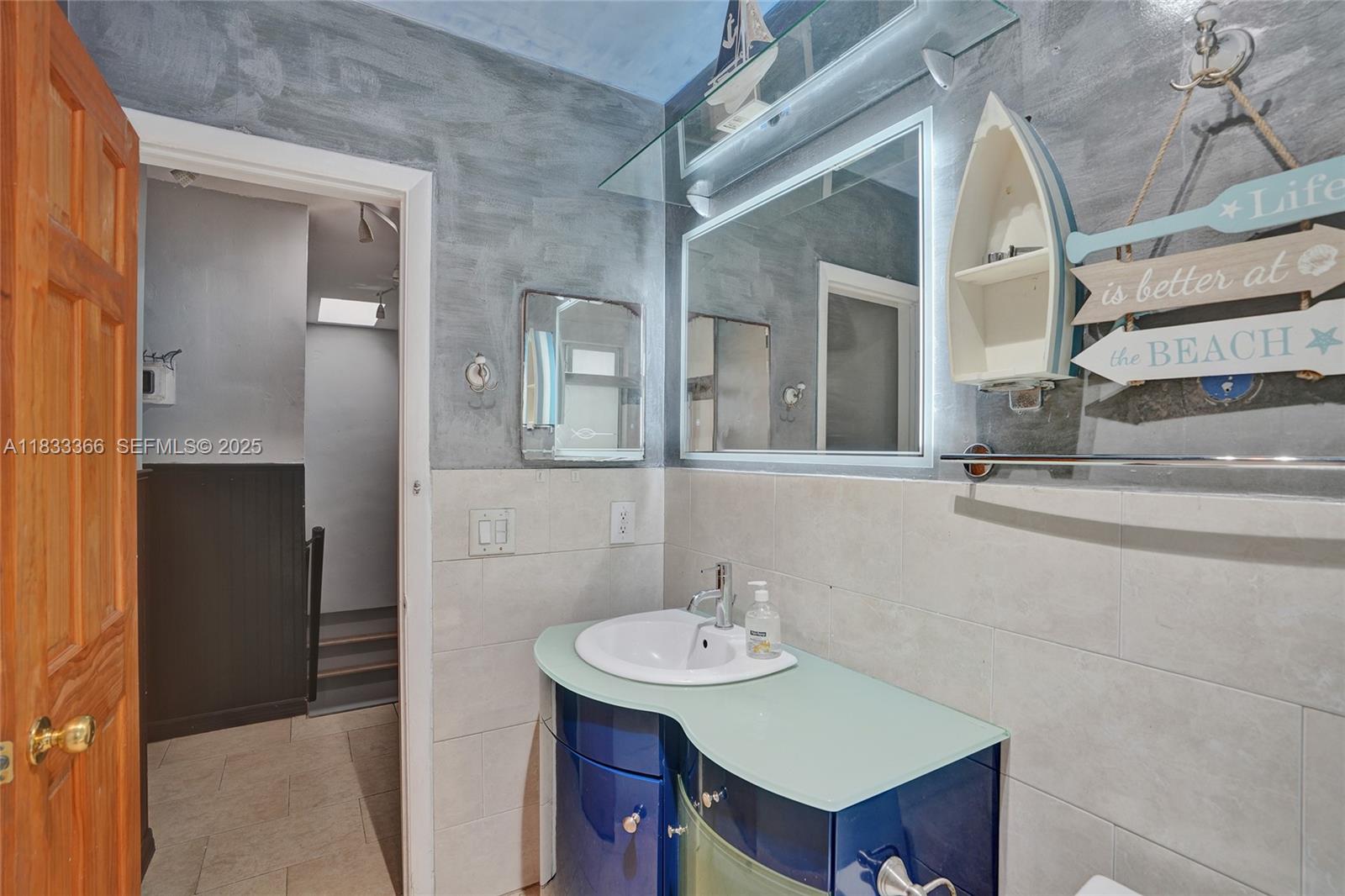 5840 Southwest 19th Street Plantation, FL 33317 - Photo 25 of 66 a bathroom with a sink and a mirror