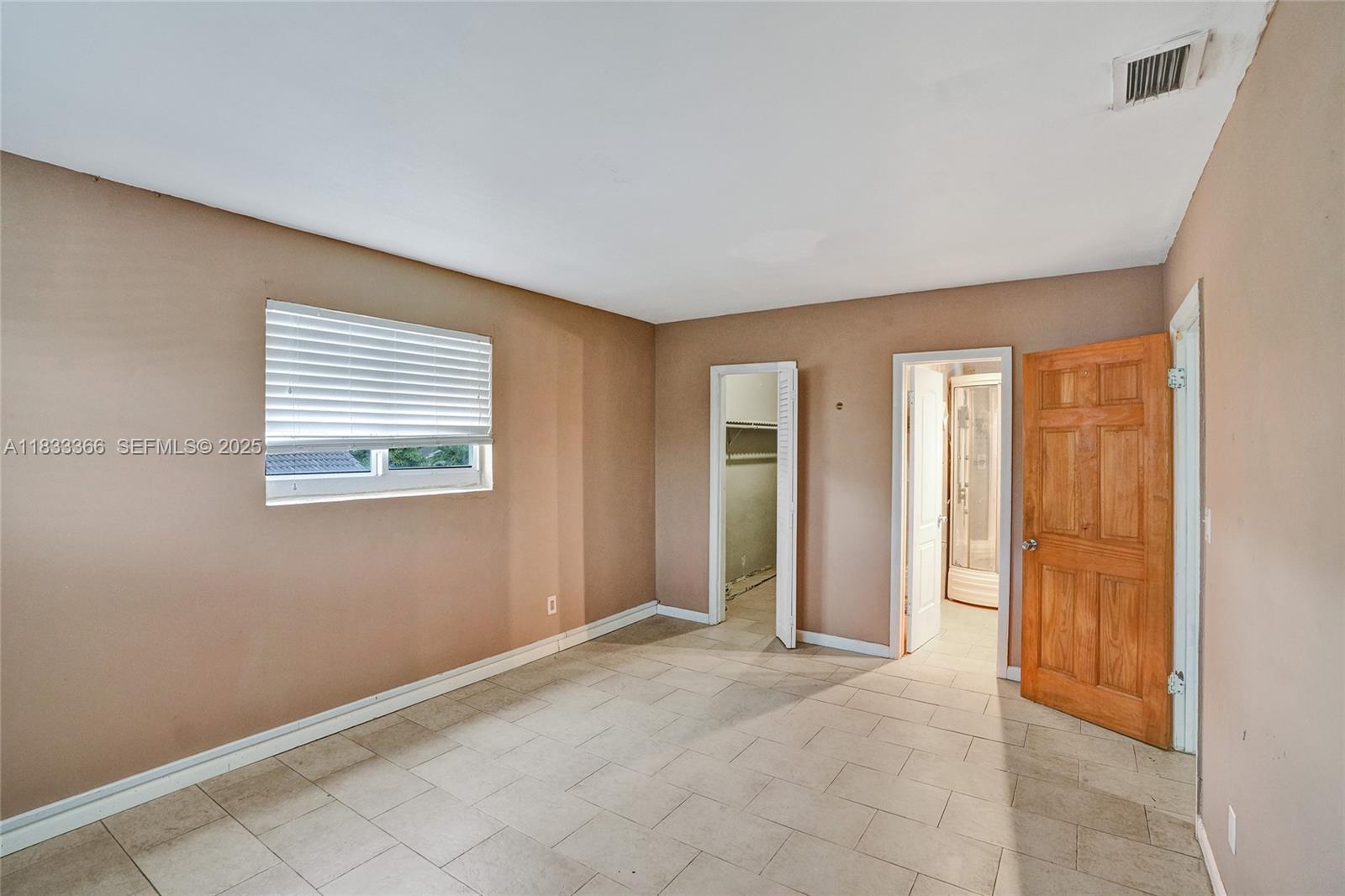 5840 Southwest 19th Street Plantation, FL 33317 - Photo 32 of 66 an empty room with windows