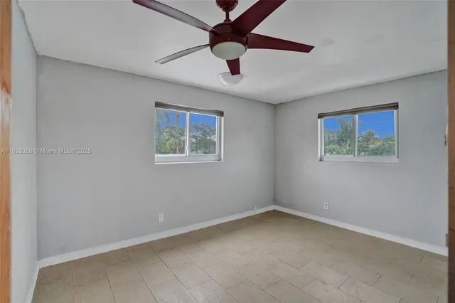 a view of a livingroom with furniture and chandelier fan