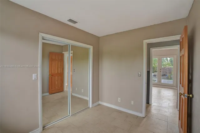 a view of a house with a yard and a tree
