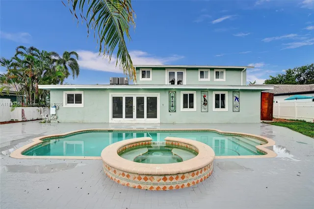 a kitchen with kitchen island sink stove and refrigerator