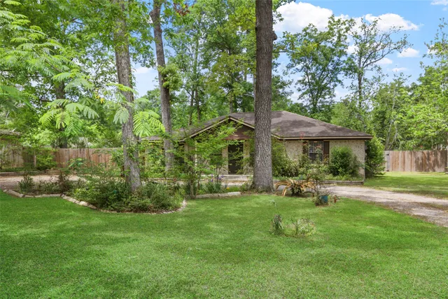 a view of a house with a yard and sitting area