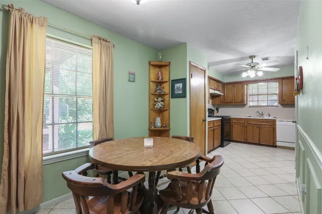 a kitchen with stainless steel appliances kitchen island granite countertop a kitchen island a stove a table and chairs