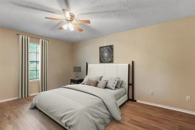 a bedroom with a large bed and a chandelier