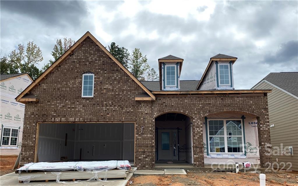 3230 Windhaven Lane, Unit 106 Tega Cay, SC 29708 - Photo 1 of 5 a front view of a house with a yard
