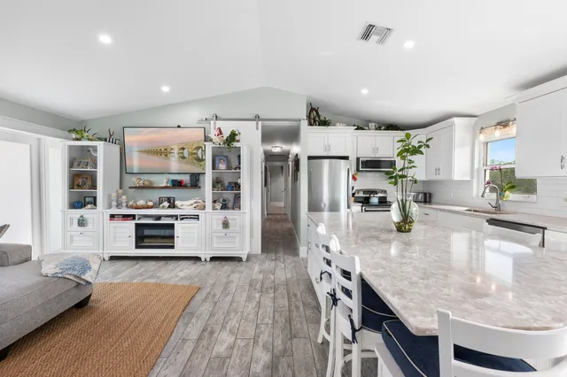 a large kitchen with stainless steel appliances kitchen island granite countertop a large counter top stainless steel appliances and cabinets