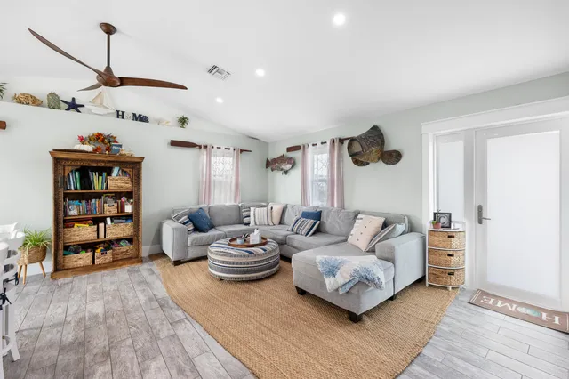 a living room with furniture and wooden floor
