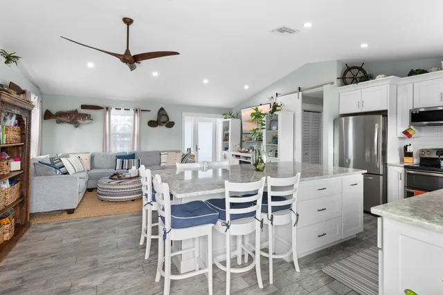 a large kitchen with a table and chairs