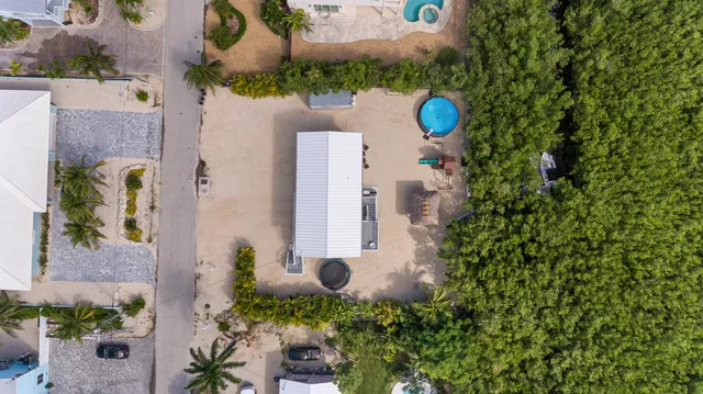 an aerial view of a house with a yard and garden