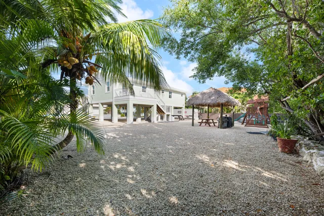 a view of a large trees in front of house