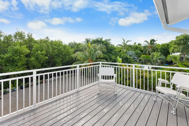 a balcony with wooden floor and fence