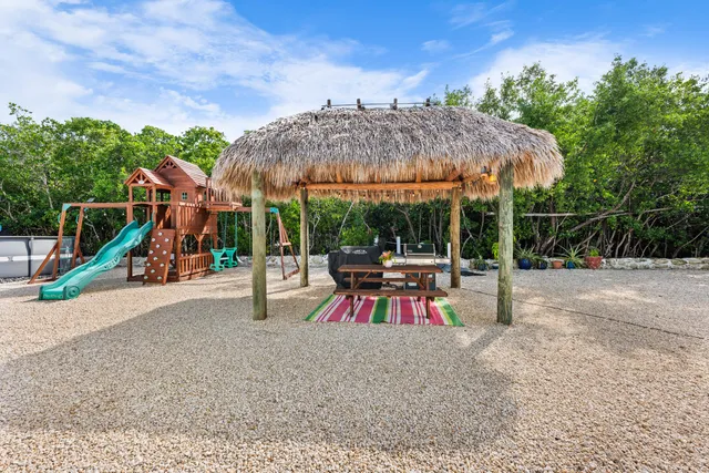 an outdoor space with patio and white umbrellas