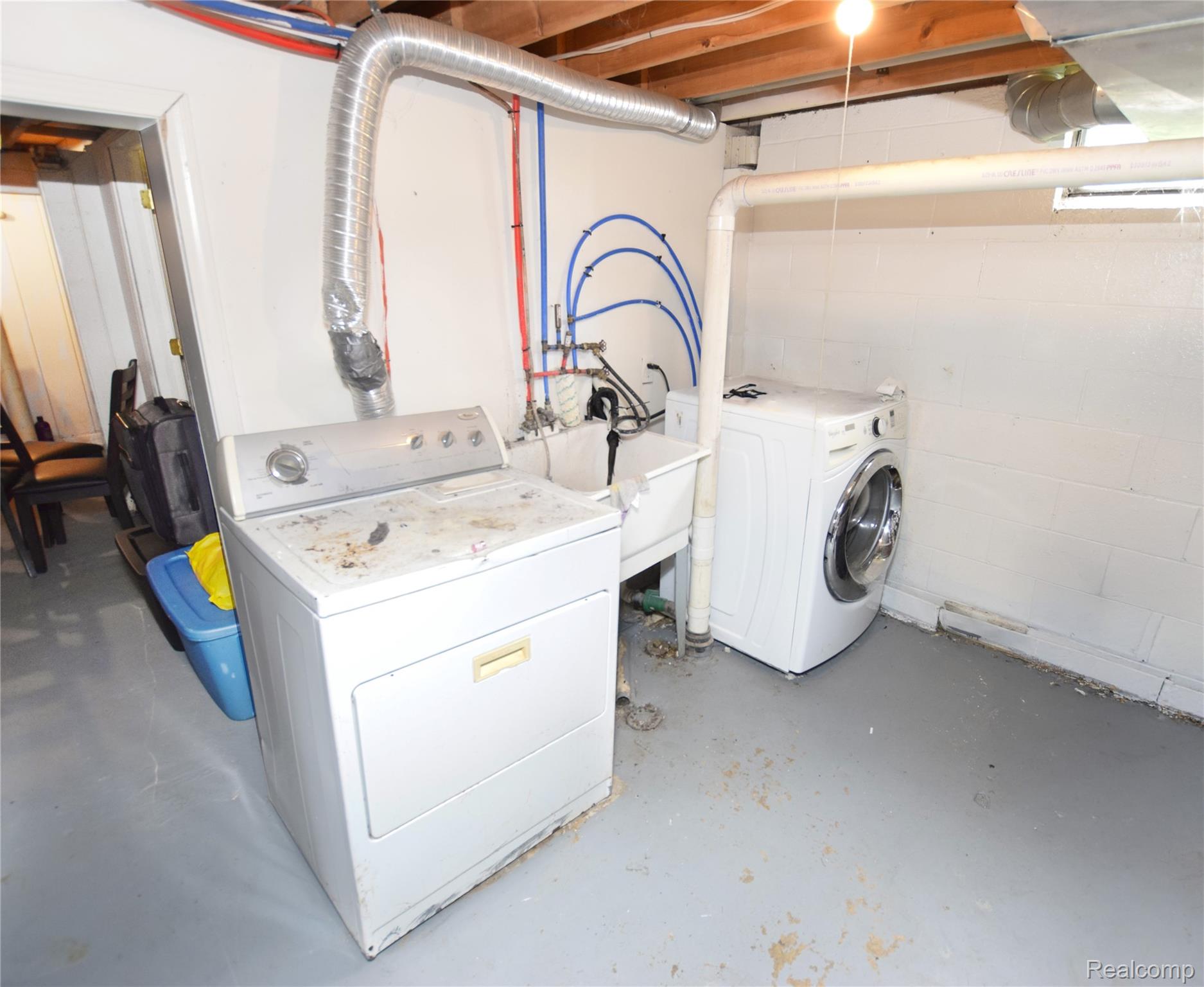 4301 Pengelly Road Flint, MI 48507 - Photo 11 of 16 Laundry area featuring concrete flooring and washing machine and clothes dryer