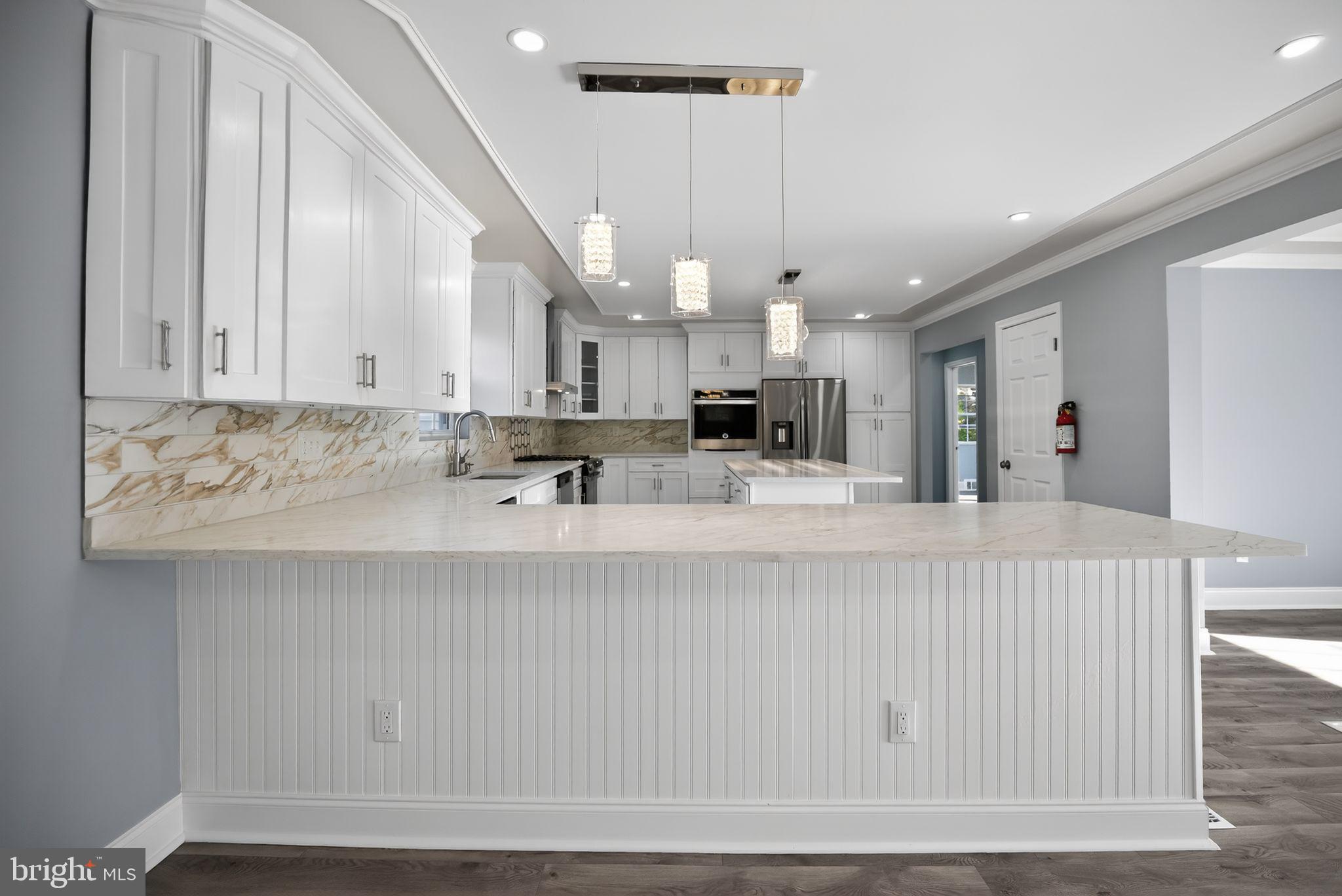 931 Woodlane Road Westampton, NJ 08060 - Photo 16 of 33 a living room with kitchen island furniture and a chandelier
