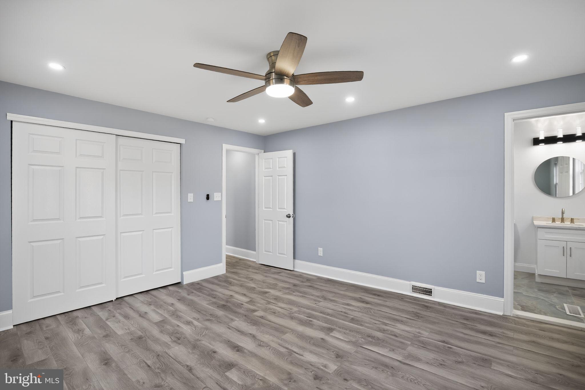 931 Woodlane Road Westampton, NJ 08060 - Photo 24 of 33 an empty room with wooden floor cabinet and windows